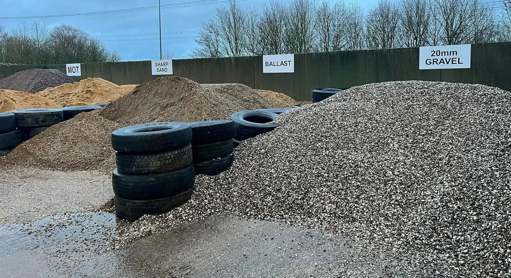 Bays of MOT, sharp sand, ballast and 20mm gravel at the Sandy Grab Services yard